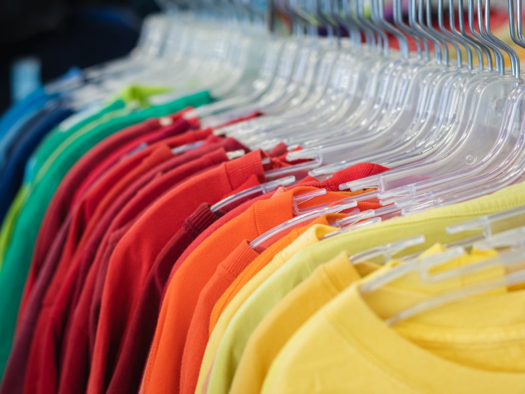 a rack of shirts hanging on a rack in a store