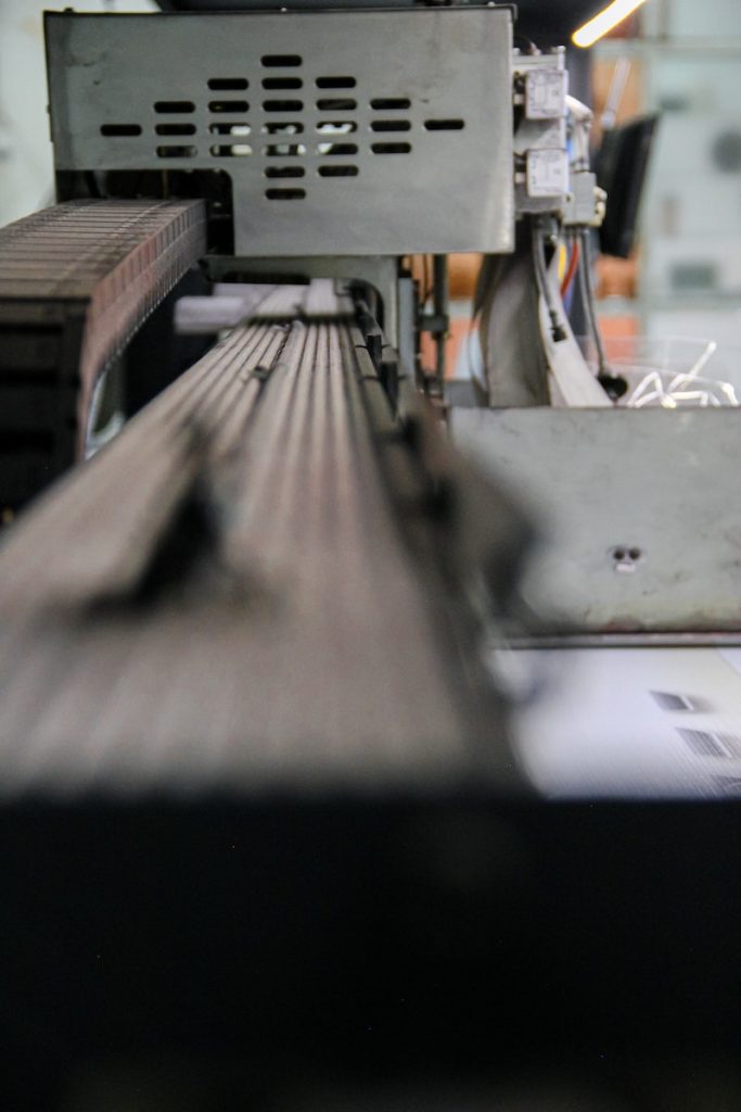 a close up of a machine cutting a piece of wood